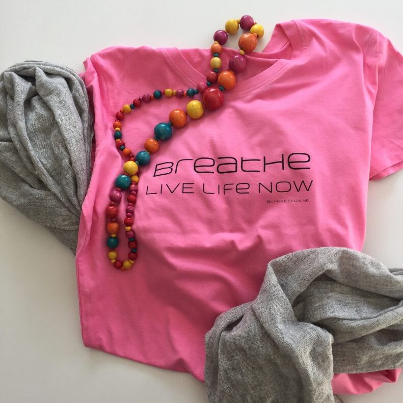 Pink t-shirt with quote; Breathe live life now.